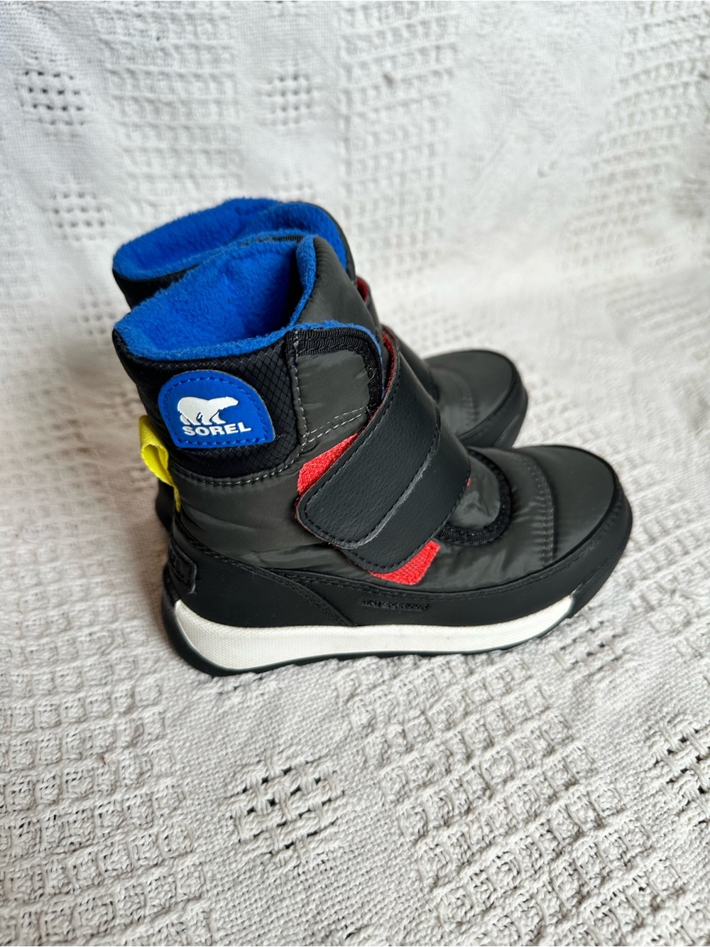 Sorel Kids Black Winter Boots with Blue Lining and Red Accents